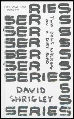 Two dogs walking on a dirt road